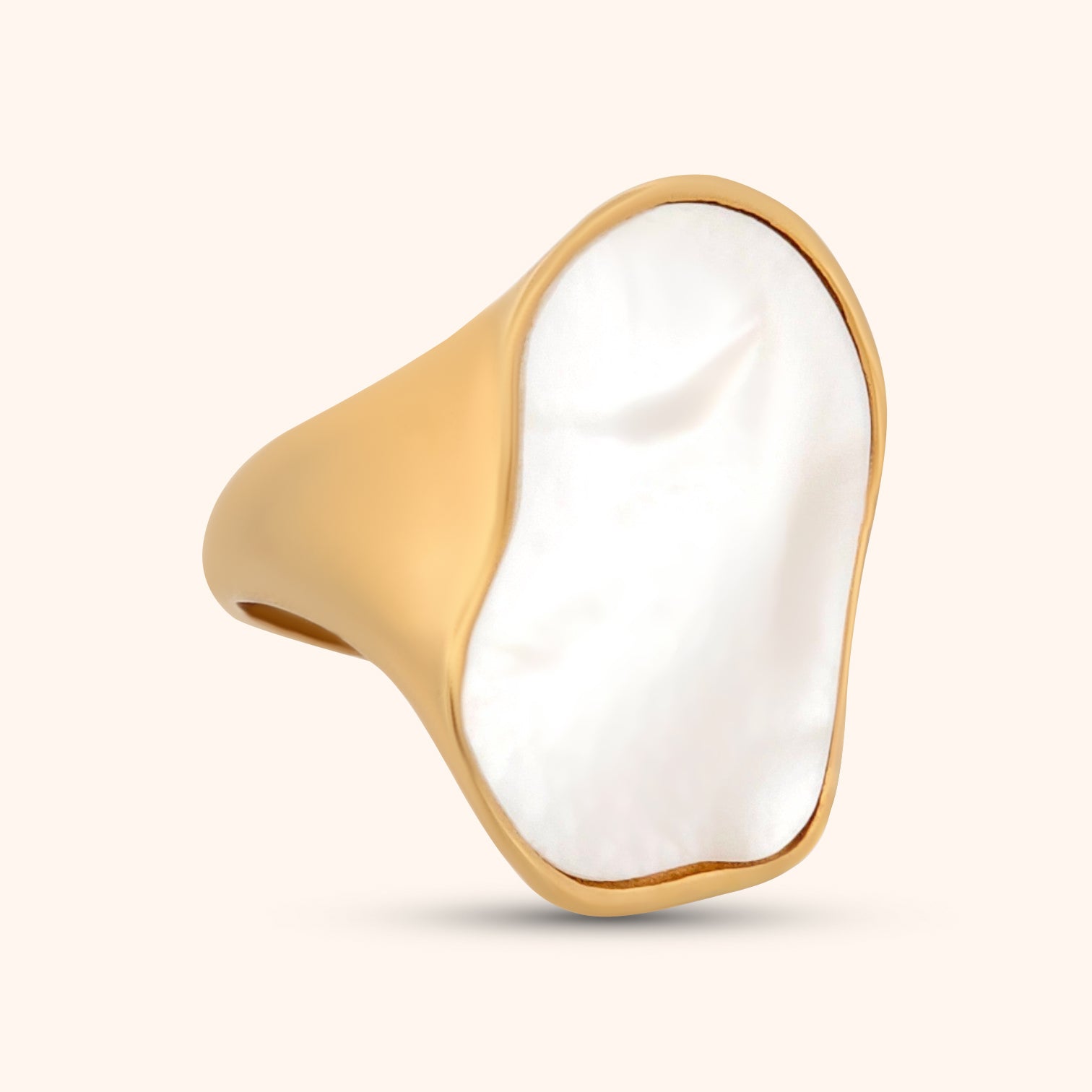 Close-up of an abstract mother of pearl ring with a sleek gold band, showcasing its unique shape and iridescent shimmer against a clean white background.